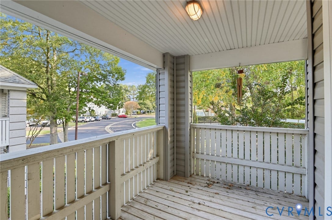 910 Rue Marseille, Les Chateaux, Chesapeake, VA 23320 Covered porch with wood decking, horizontal slat railings, beadboard ceiling, and flush-mount exterior lighting