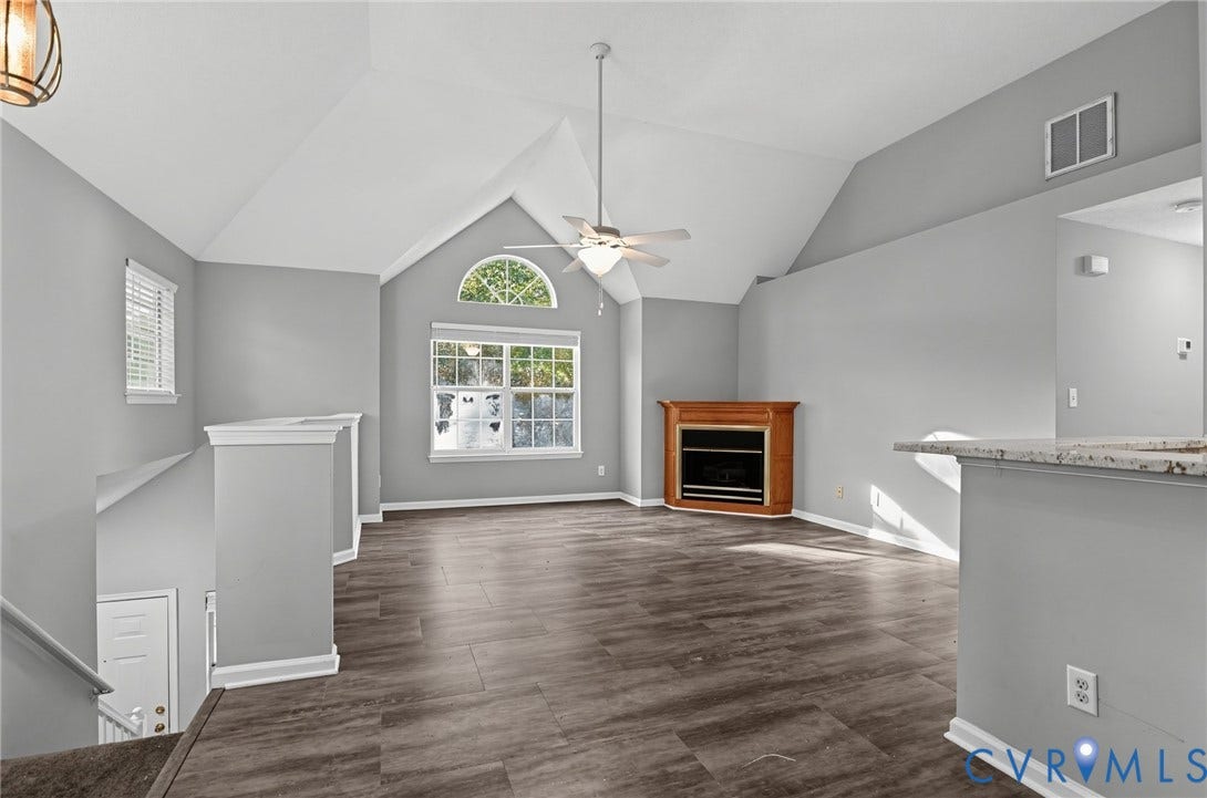 910 Rue Marseille, Les Chateaux, Chesapeake, VA 23320 Vaulted ceiling, wood-finish flooring, corner fireplace with wood mantle, and arched window