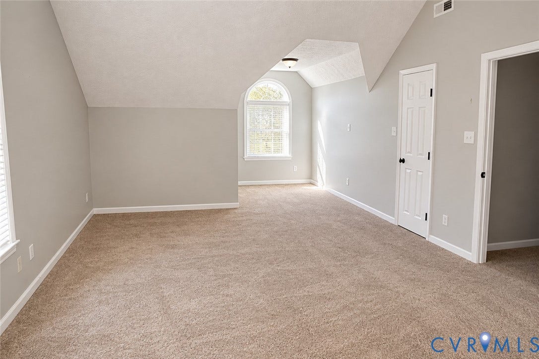 4229 Cedar Creek Lane, Prince George, VA 23875 Vaulted ceilings, arched window with muntin detailing, neutral carpeting, and interior six-panel doors