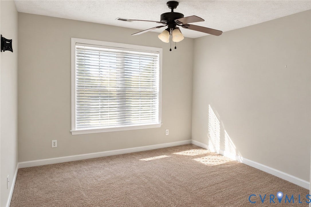 4229 Cedar Creek Lane, Prince George, VA 23875 Neutral wall coloring, wall-to-wall carpeting, single-pane window with horizontal blinds, and a multi-bulb ceiling fan with an integrated light fixture
