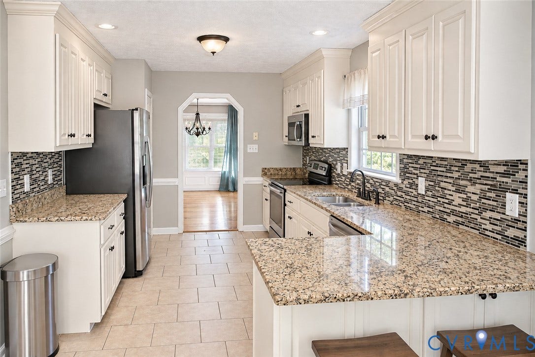 4229 Cedar Creek Lane, Prince George, VA 23875 Kitchen featuring white shaker-style cabinetry, stone-finish countertops, decorative mosaic tile backsplash, stainless steel appliances, and ceramic tile flooring