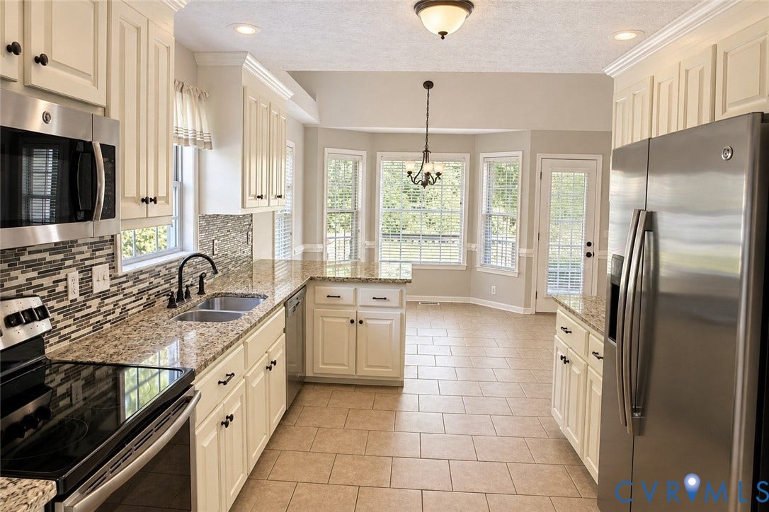 4229 Cedar Creek Lane, Prince George, VA 23875 Kitchen featuring custom cabinetry, stone-finish countertops, decorative tile backsplash, stainless steel appliances, and tile flooring