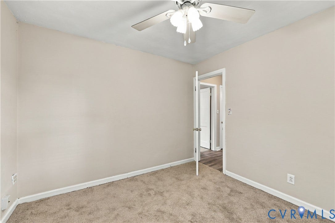 305 Arizona Street, Kingman Heights, Portsmouth, VA 23701 Room featuring neutral wall tones, carpeted flooring, and a ceiling-mounted light fixture with a three-blade fan