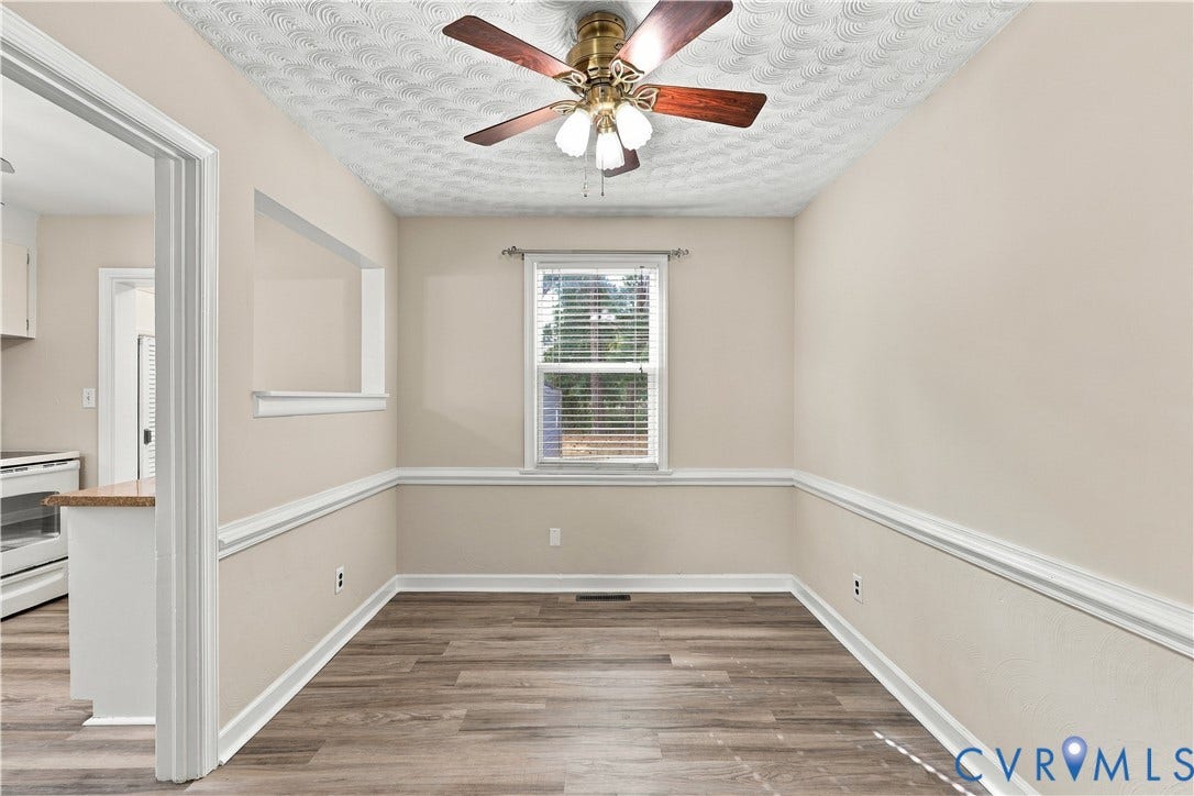 305 Arizona Street, Kingman Heights, Portsmouth, VA 23701 Wood-finish flooring, chair rail molding, ceiling fan with integrated lighting, textured ceiling, and an interior pass-through opening