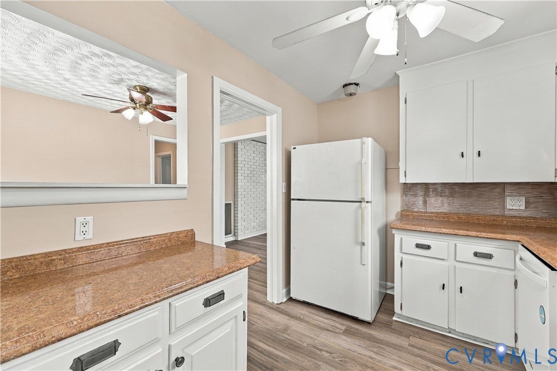 305 Arizona Street, Kingman Heights, Portsmouth, VA 23701 Kitchen featuring white cabinetry, stone-finish countertops, wood-finish flooring, a wall-mounted mirror, and a ceiling fan with integrated lighting