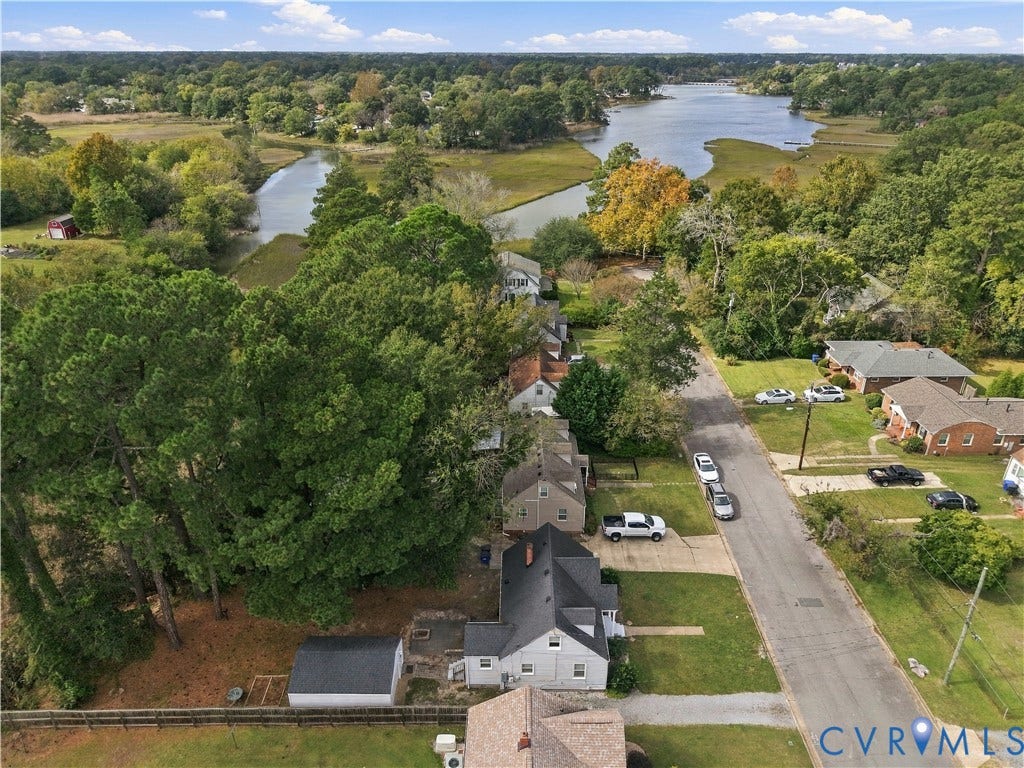 305 Arizona Street, Kingman Heights, Portsmouth, VA 23701 Aerial perspective featuring a residential lot with mature trees and a detached structure, situated within proximity to coastal waterways and dense natural foliage