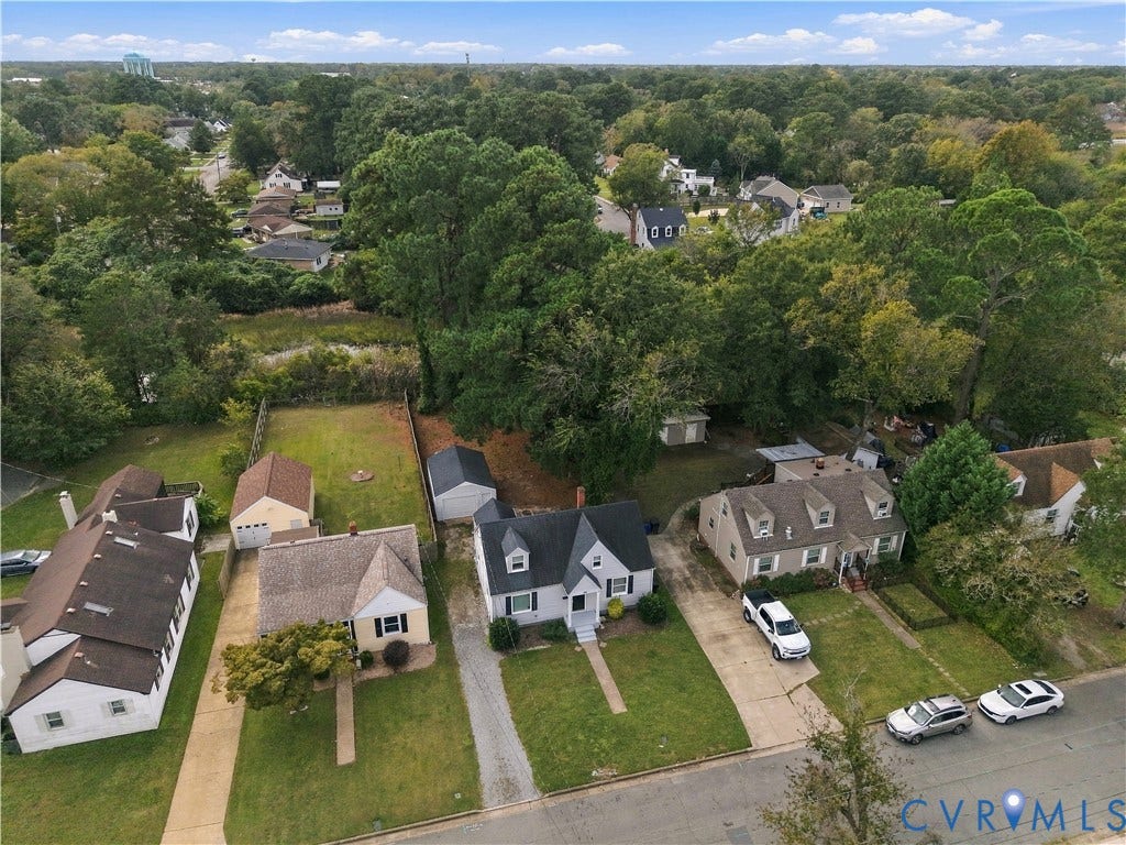 305 Arizona Street, Kingman Heights, Portsmouth, VA 23701 Aerial view featuring a two-story residence with a gabled roof, detached garage, and mature tree canopy on a lot with grass landscaping