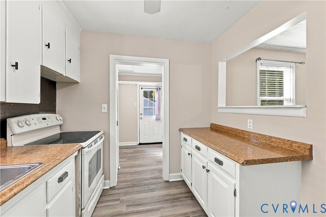 305 Arizona Street, Kingman Heights, Portsmouth, VA 23701 Kitchen featuring white cabinetry, stone-finish countertops, an integrated pass-through window, and wood-finish flooring