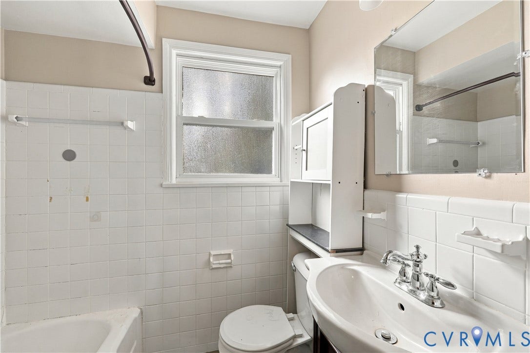 305 Arizona Street, Kingman Heights, Portsmouth, VA 23701 Bathroom featuring white wall tiling, a pedestal sink with chrome faucet hardware, built-in medicine cabinet shelving, and a single-hung window with privacy glass