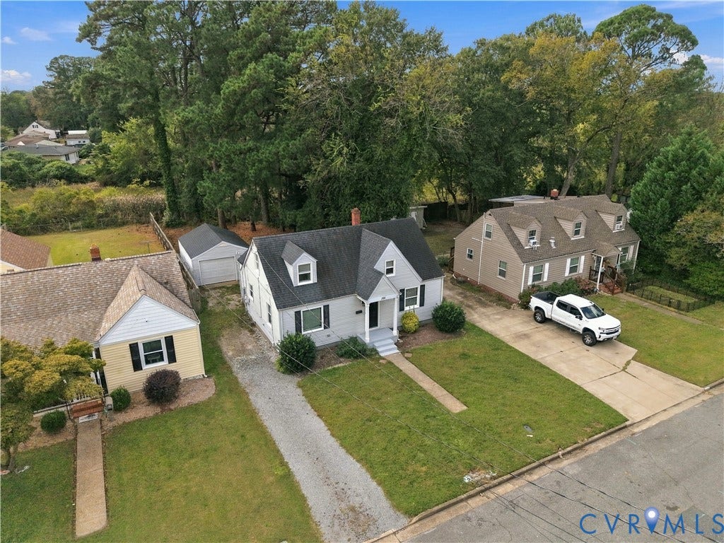 305 Arizona Street, Kingman Heights, Portsmouth, VA 23701 Cape Cod exterior featuring a gabled roofline, dormer windows, a covered front entryway, and a detached single-car garage