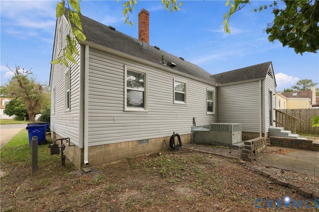 305 Arizona Street, Kingman Heights, Portsmouth, VA 23701 Exterior featuring light-toned horizontal siding, a brick chimney, and a concrete paver patio