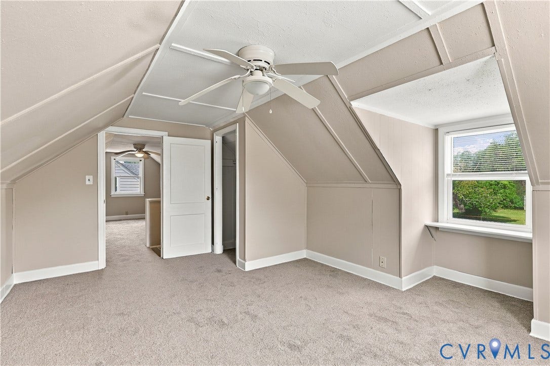 305 Arizona Street, Kingman Heights, Portsmouth, VA 23701 Interior room featuring sloped ceilings, wall-to-wall carpeting, a ceiling fan with integrated lighting, and dual-pane windows