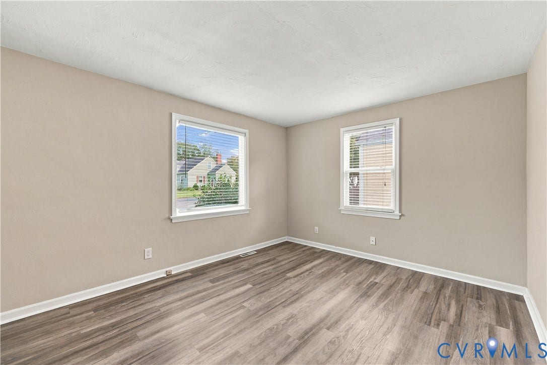 305 Arizona Street, Kingman Heights, Portsmouth, VA 23701 Neutral-toned walls, wood-finish flooring, and two double-hung windows