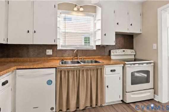 305 Arizona Street, Kingman Heights, Portsmouth, VA 23701 Kitchen featuring white shaker-style cabinetry, solid-surface countertops, dual-basin stainless steel sink, and wood-finish flooring