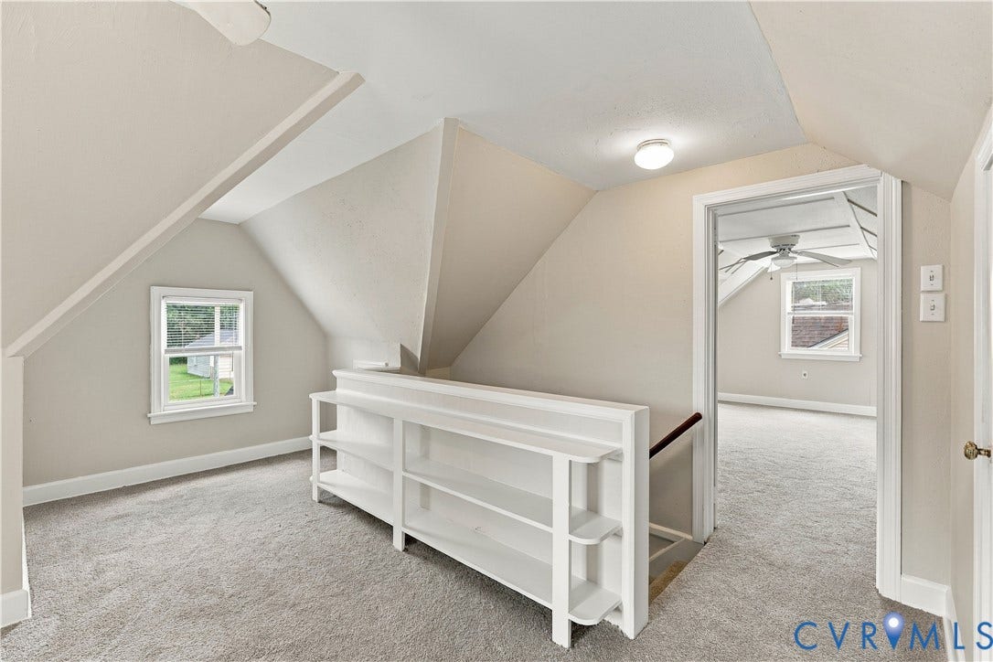 305 Arizona Street, Kingman Heights, Portsmouth, VA 23701 Vaulted ceilings with architectural roof lines, built-in shelving, neutral wall tones, and double-hung windows