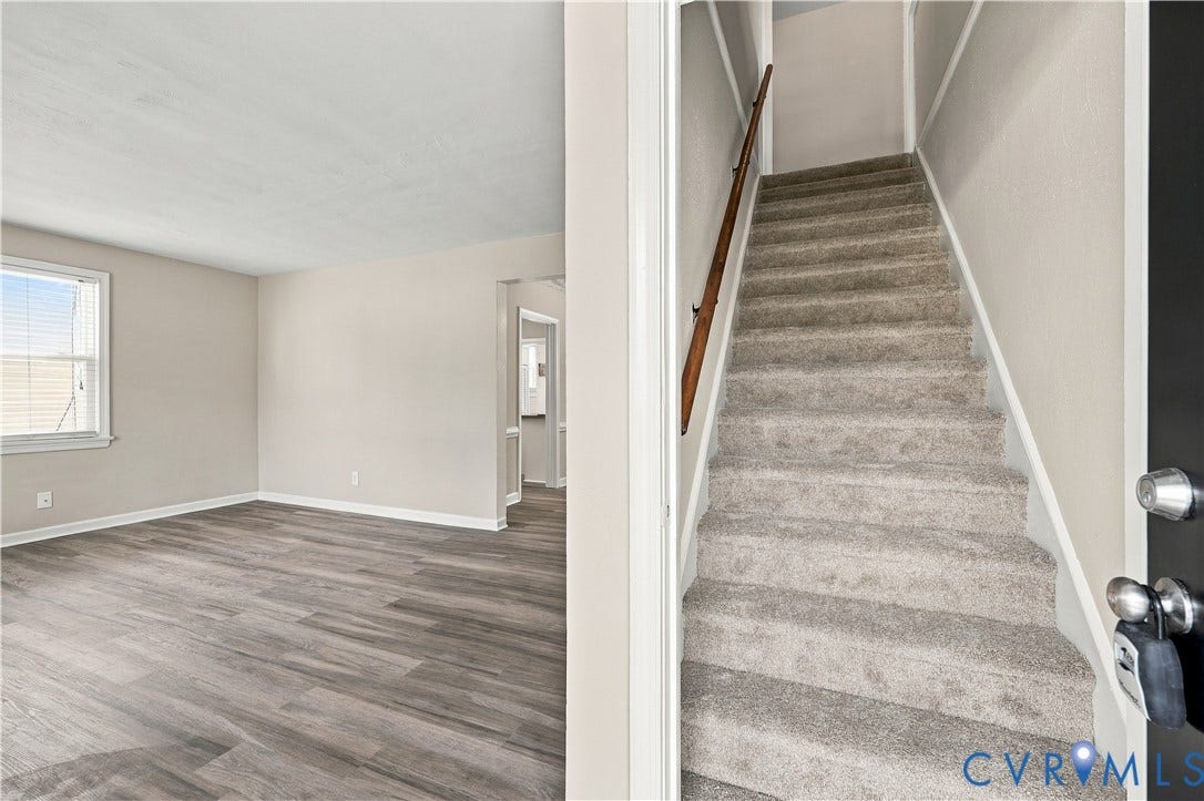 305 Arizona Street, Kingman Heights, Portsmouth, VA 23701 Wood-finish flooring, staircase with carpeted treads, wall-mounted wooden handrail, and neutral interior paint