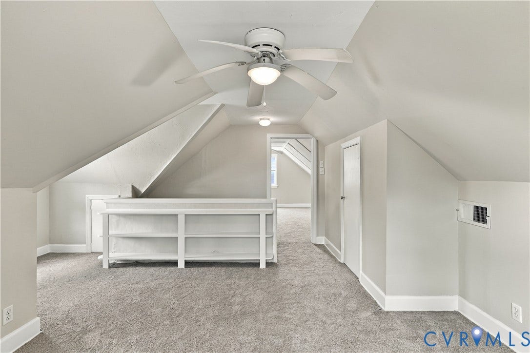 305 Arizona Street, Kingman Heights, Portsmouth, VA 23701 Vaulted ceilings featuring a white-painted finish, built-in shelving unit, neutral carpet flooring, and a ceiling fan with integrated light fixture