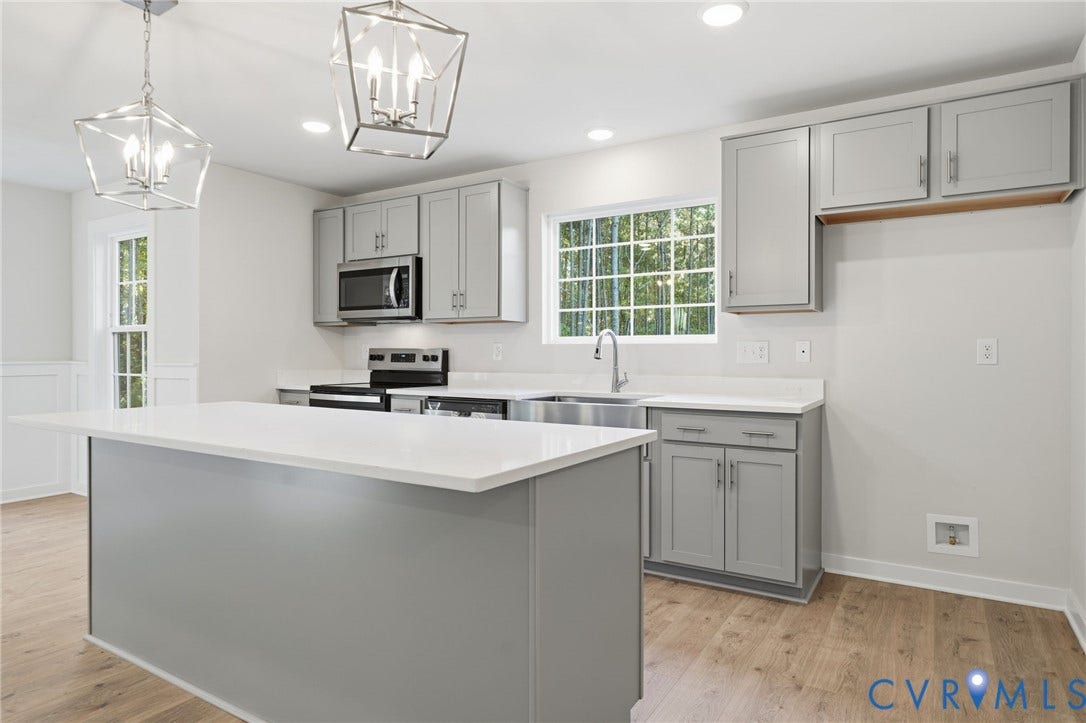 8209 Grantham Woods Way, Grantham Woods, Henrico, VA 23231 Kitchen featuring grey shaker-style cabinetry, quartz countertops, a central island, stainless steel appliances, and wood-finish flooring