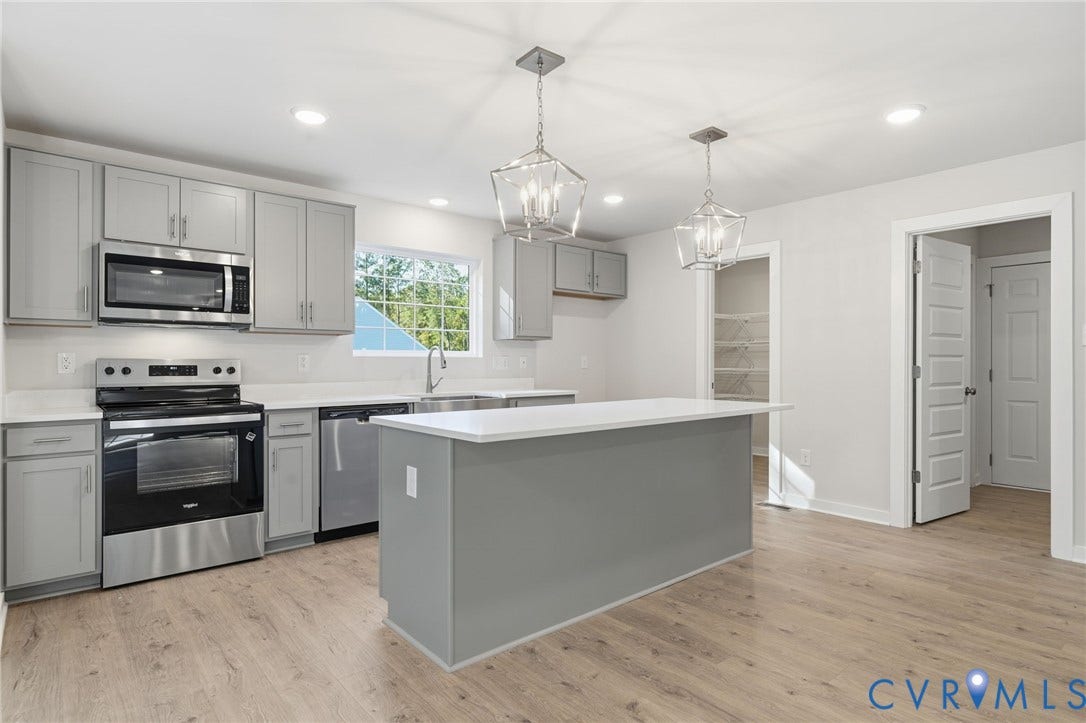 8209 Grantham Woods Way, Grantham Woods, Henrico, VA 23231 Kitchen featuring light gray cabinetry, quartz countertops, stainless steel appliances, a central island, and wood-finish flooring