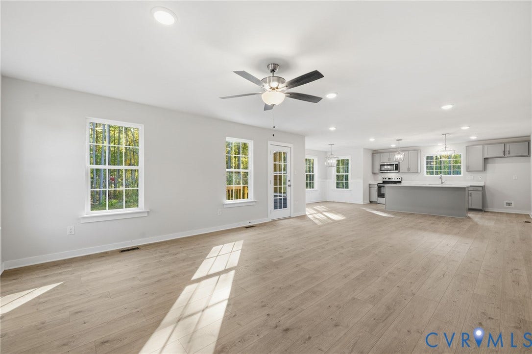 8209 Grantham Woods Way, Grantham Woods, Henrico, VA 23231 Open-concept interior featuring wood-finish flooring, recessed lighting, a ceiling fan, and a kitchen equipped with a central island and cabinetry