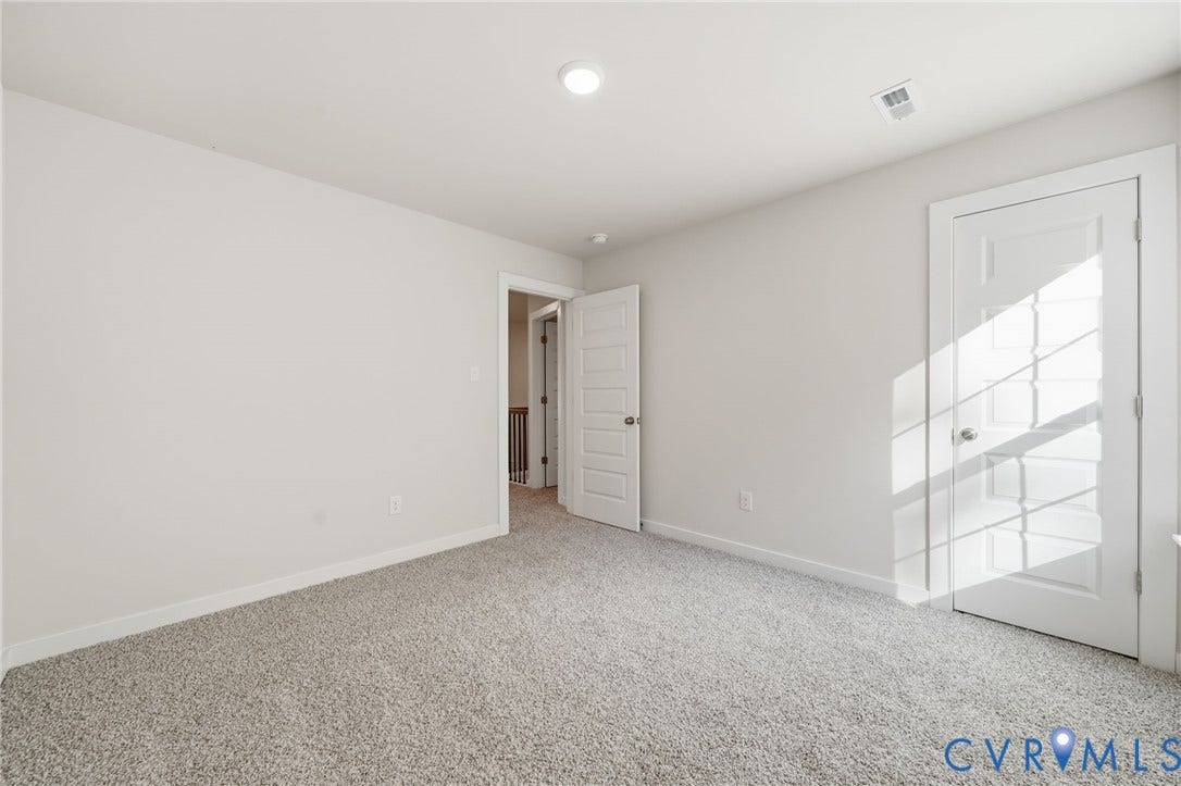 8209 Grantham Woods Way, Grantham Woods, Henrico, VA 23231 Neutral-toned wall paint, plush carpeting, recessed lighting, and multi-panel interior doors