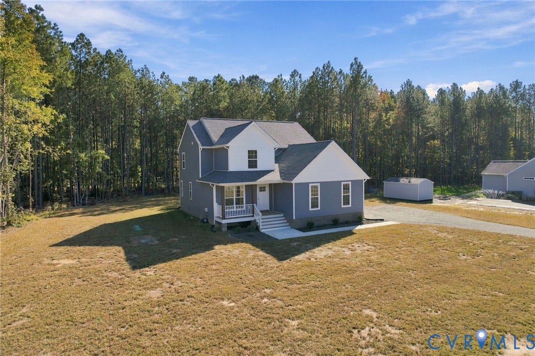 8209 Grantham Woods Way, Grantham Woods, Henrico, VA 23231 Two-story home featuring dual-tone siding, an attached front porch, stone foundation detailing, and an exterior storage structure on an expansive lot