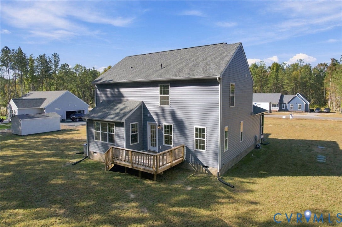 8209 Grantham Woods Way, Grantham Woods, Henrico, VA 23231 Two-story residence featuring gray vinyl siding, an asphalt shingle roof, a detached garage, and a wood deck