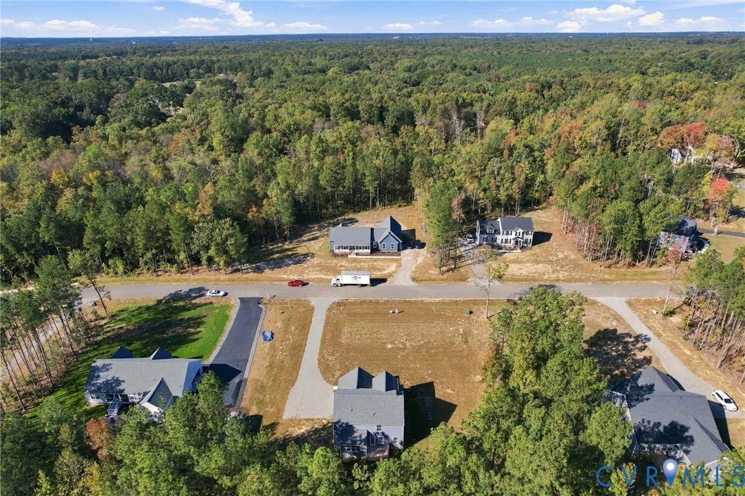 8209 Grantham Woods Way, Grantham Woods, Henrico, VA 23231 Aerial perspective featuring residential lots with paved driveways, established asphalt street infrastructure, and heavy perimeter forest coverage