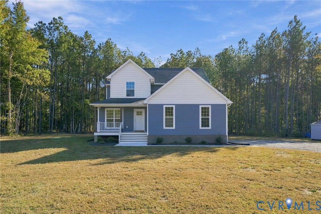 8209 Grantham Woods Way, Grantham Woods, Henrico, VA 23231 Two-story residence featuring blue and white horizontal siding, a covered front porch, brick foundation detailing, and a shingled roof