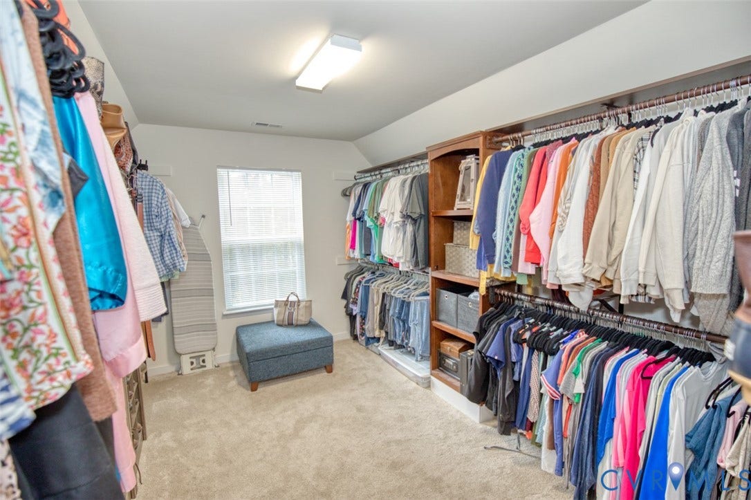 13501 Cooks Mill Court, Cooks Mill, Lanexa, VA 23089 Walk-in closet featuring tiered clothing rods, integrated wood-finish shelving, wall-to-wall carpeting, and a single window