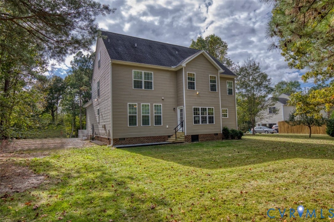 13501 Cooks Mill Court, Cooks Mill, Lanexa, VA 23089 Two-story residence featuring light-toned horizontal siding, a brick foundation perimeter, a shingled roof, and an expansive lawn