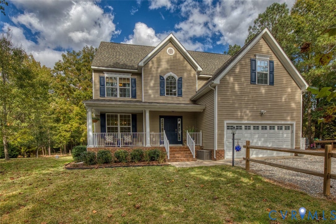 13501 Cooks Mill Court, Cooks Mill, Lanexa, VA 23089 Two-story residence featuring horizontal siding, a covered front porch with white railing, brick-accented stairs, a multi-gabled roofline, and a multi-car garage