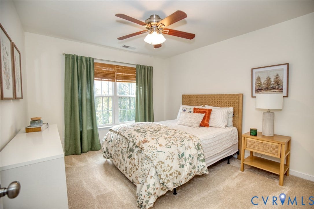 13501 Cooks Mill Court, Cooks Mill, Lanexa, VA 23089 Neutral-toned wall-to-wall carpeting, multi-pane window with wood-slat blinds, and a central ceiling fan with integrated lighting