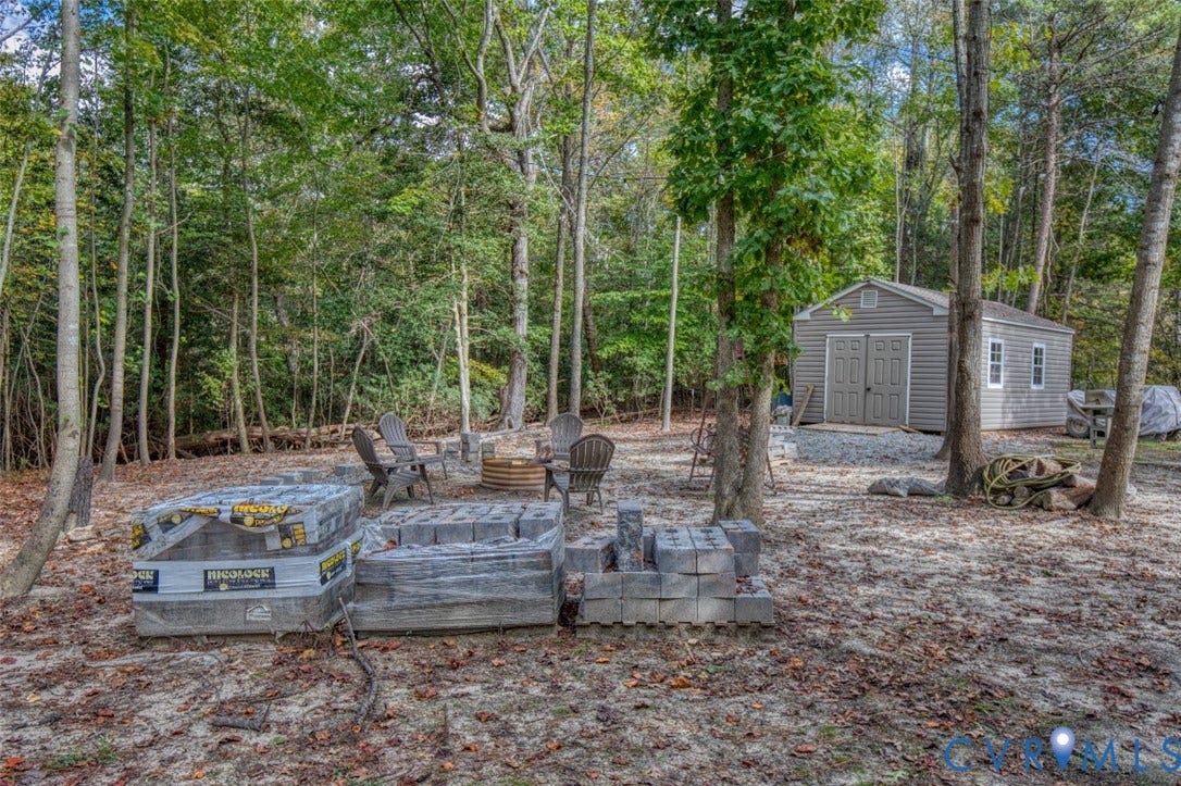 13501 Cooks Mill Court, Cooks Mill, Lanexa, VA 23089 Wooded lot featuring a detached storage building with vinyl siding and a gravel foundation