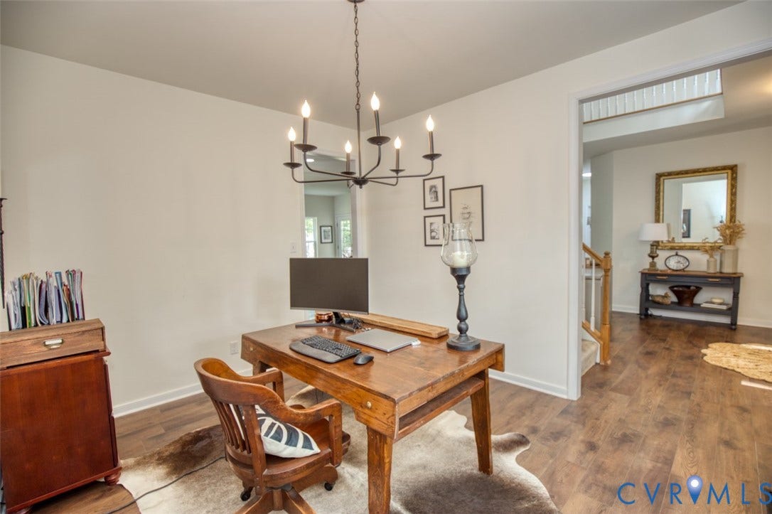 13501 Cooks Mill Court, Cooks Mill, Lanexa, VA 23089 Interior room featuring wood-finish flooring, a matte black metal candelabra-style chandelier, and a wood banister with white balusters