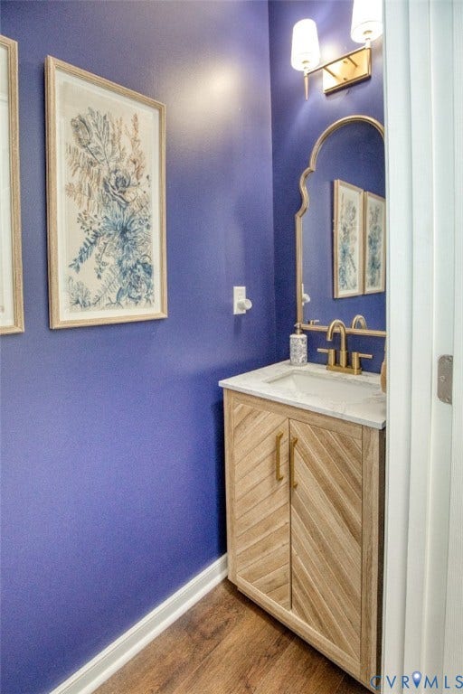 13501 Cooks Mill Court, Cooks Mill, Lanexa, VA 23089 Custom wood-finish vanity with herringbone-patterned cabinetry, white stone-composite countertop, arched wall mirror, metallic finish faucet, and dual-shade wall sconce