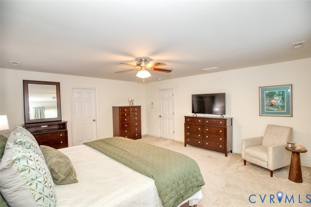 13501 Cooks Mill Court, Cooks Mill, Lanexa, VA 23089 Neutral-toned carpeted flooring, multi-panel interior doors, and a central ceiling fan with integrated lighting