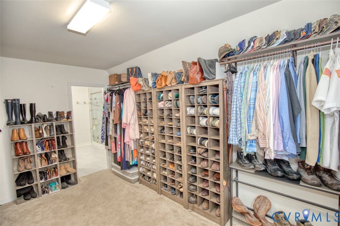 13501 Cooks Mill Court, Cooks Mill, Lanexa, VA 23089 Walk-in closet featuring extensive built-in shelving, modular cubbies, wall-to-wall carpeting, and linear hanging rods