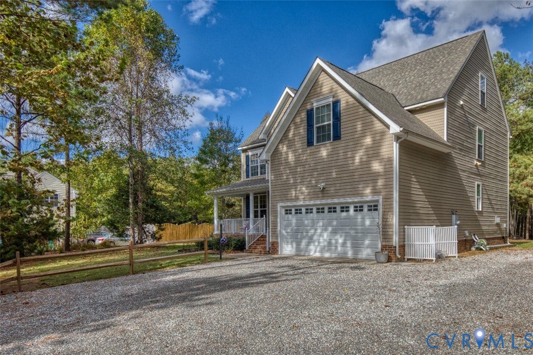 13501 Cooks Mill Court, Cooks Mill, Lanexa, VA 23089 Two-story residence featuring horizontal siding, a gabled roofline, an attached two-car garage, and a covered front porch with white railing