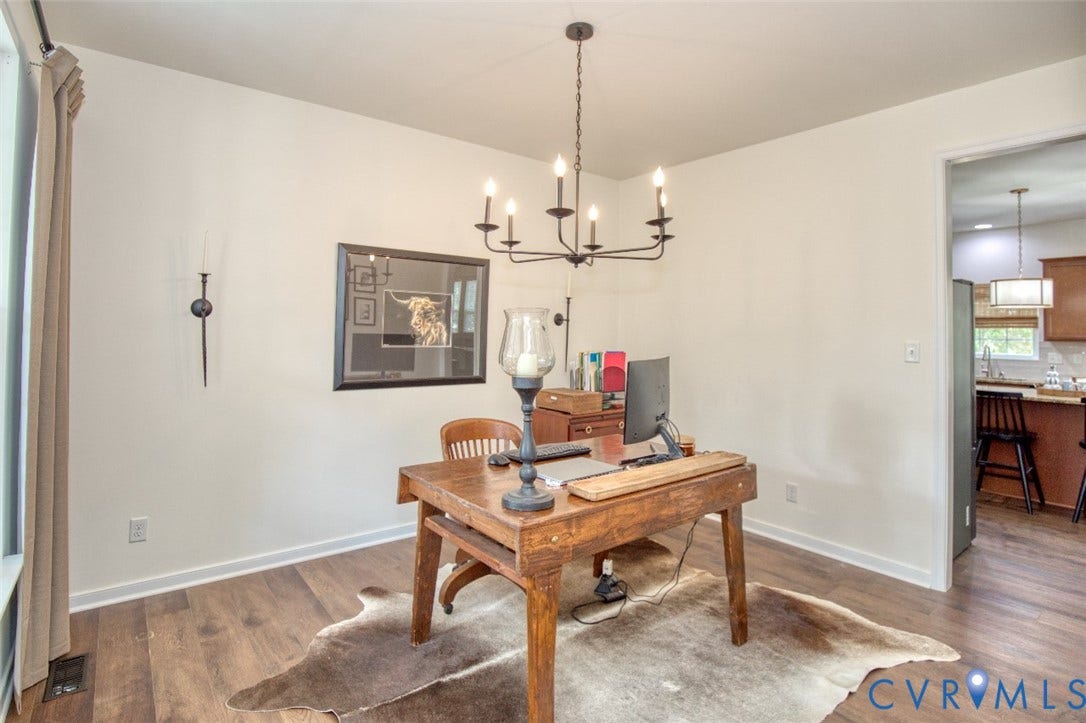 13501 Cooks Mill Court, Cooks Mill, Lanexa, VA 23089 Room featuring wood-finish flooring, a six-arm metal chandelier, and a wall-mounted metal sconce