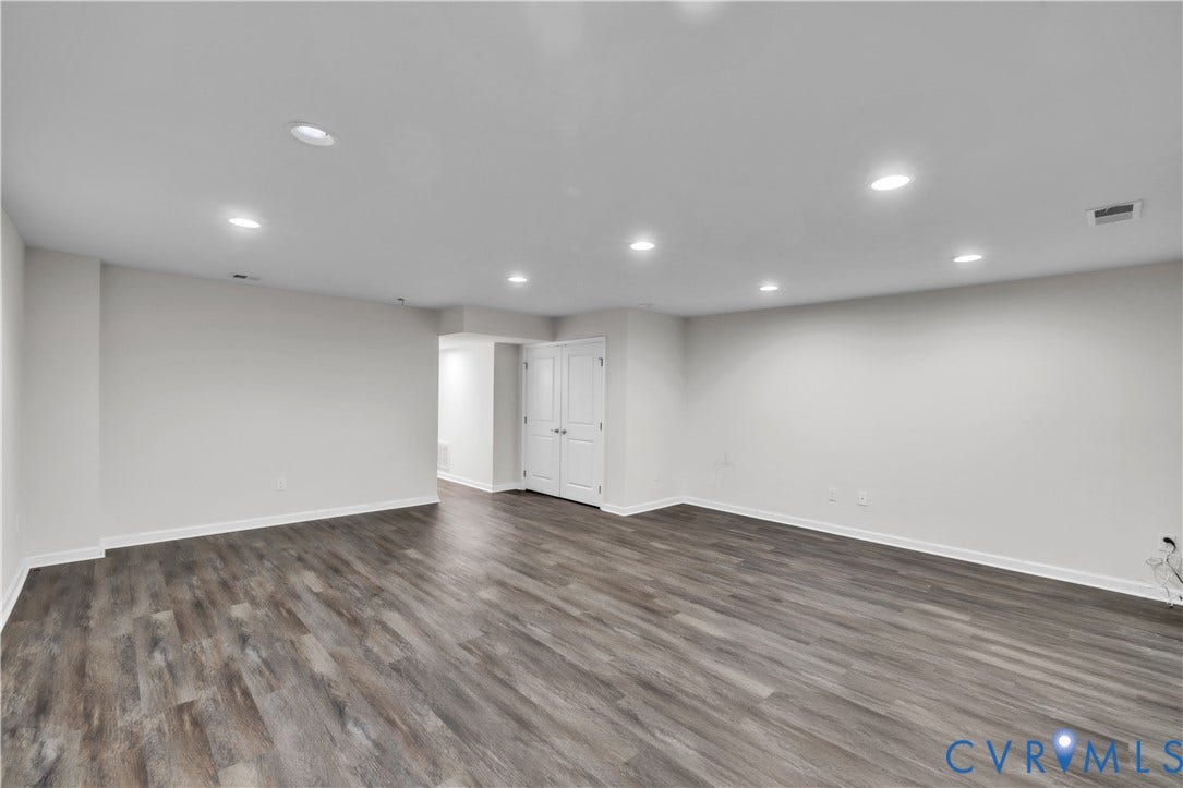 4511 Wistar Woods Trail, Richmond, VA 23228 Open-concept interior featuring wood-finish flooring, recessed lighting, and white double-door closet cabinetry