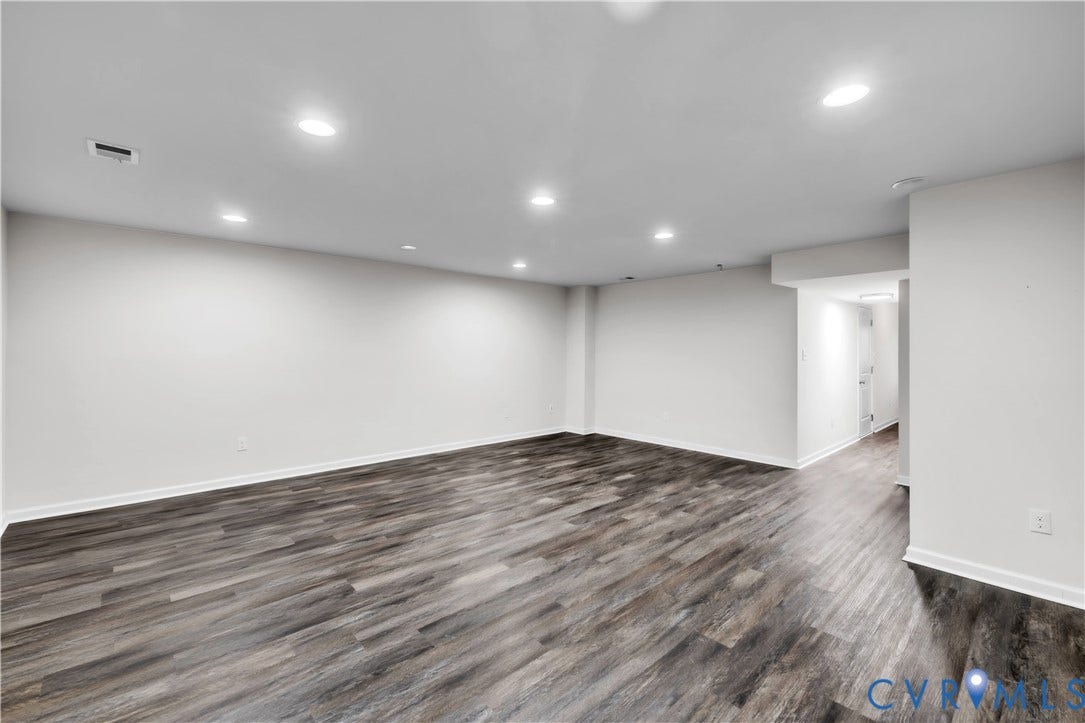 4511 Wistar Woods Trail, Richmond, VA 23228 Open-concept interior featuring neutral wall tones, wood-finish flooring, and recessed ceiling lighting