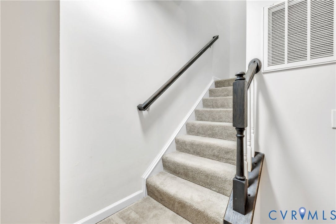 4511 Wistar Woods Trail, Richmond, VA 23228 Staircase featuring wall-to-wall carpeting, a dark-finish wood handrail, a matching dark-finish newel post, and white balusters