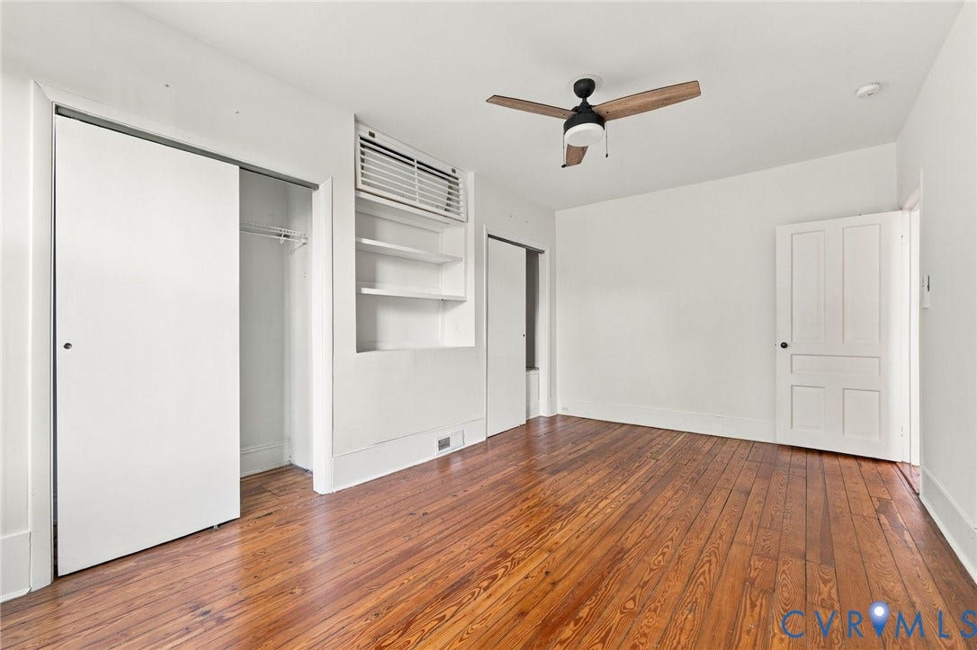 522 N 27th Street, Church Hill, Richmond, VA 23223 Front bedroom #2featuring wood-finish flooring, built-in shelving, a ceiling fan, a closet with sliding doors, and a multi-panel interior door