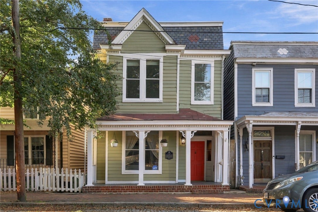 522 N 27th Street, Church Hill, Richmond, VA 23223 Two-story Victorian-style exterior featuring horizontal siding, a mansard roof with decorative shingle patterns, a covered front porch with ornate gingerbread trim, and a brick foundation