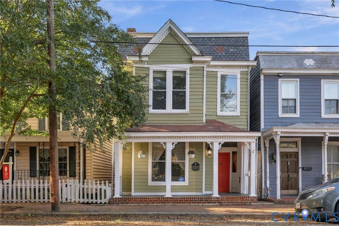 522 N 27th Street, Church Hill, Richmond, VA 23223 Two-story Victorian-style residence featuring horizontal lap siding, decorative roof shingles, a covered front porch with ornate millwork, and brick foundation detailing