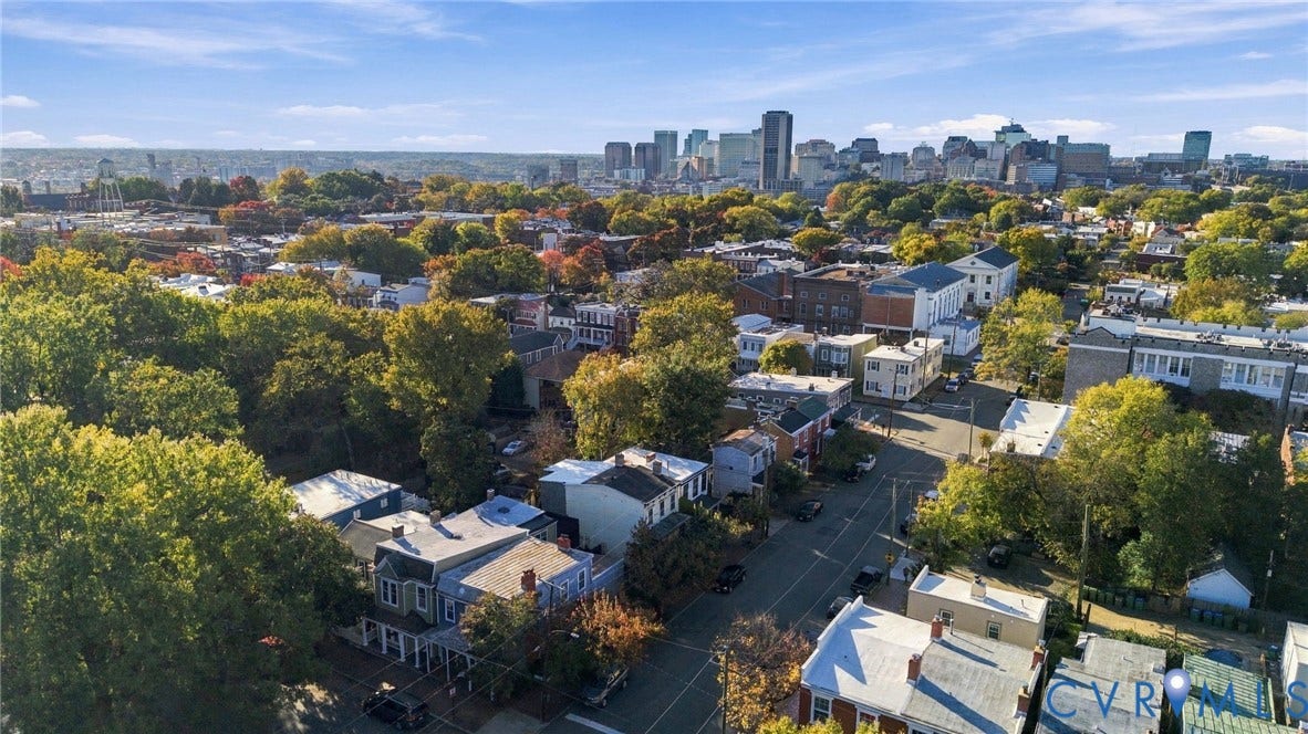 522 N 27th Street, Church Hill, Richmond, VA 23223 Aerial perspective featuring an established neighborhood with mature trees and a city skyline backdrop