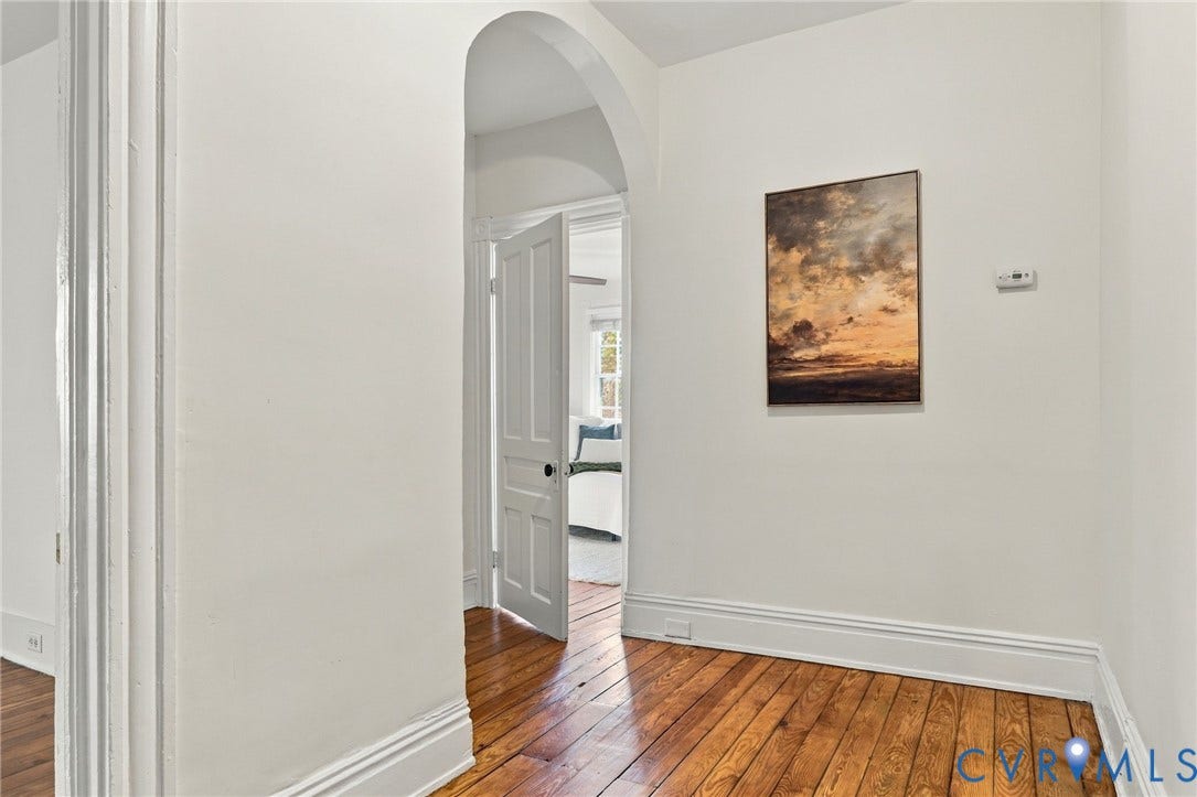522 N 27th Street, Church Hill, Richmond, VA 23223 Architectural arched opening featuring natural wood-finish flooring and a classic five-panel interior door