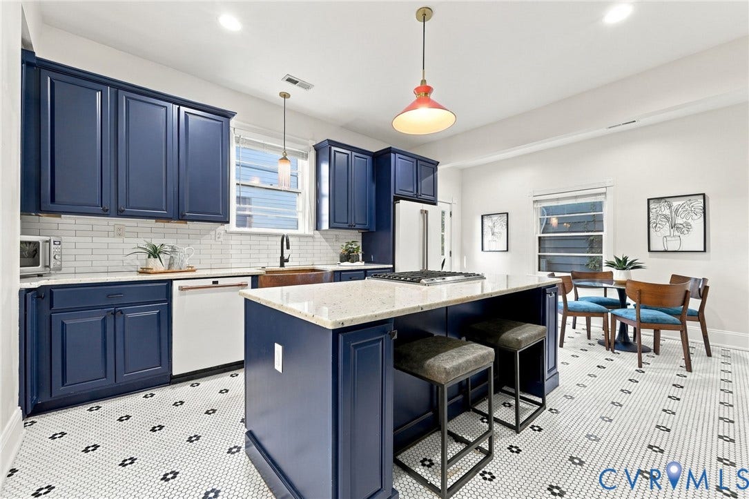 522 N 27th Street, Church Hill, Richmond, VA 23223 Kitchen featuring navy blue cabinetry, center island with stone-finish countertop, white subway tile backsplash, farmhouse-style sink, and geometric patterned floor tile