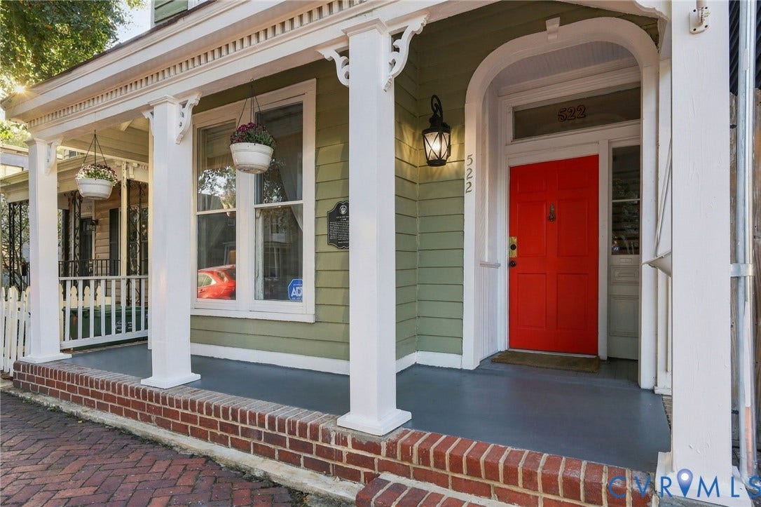 522 N 27th Street, Church Hill, Richmond, VA 23223 Covered front porch featuring decorative brackets, square columns, a transom window, and a brick-lined walkway
